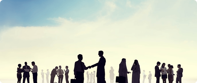 Silhouettes of people networking and shaking hands