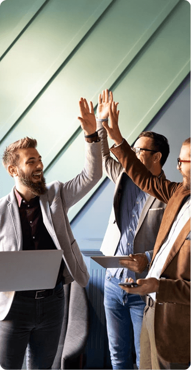 Business team celebrating success with a high-five in a modern office
