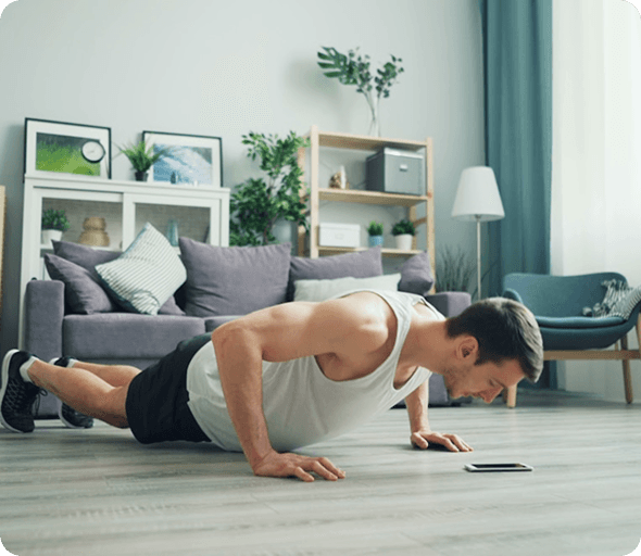 Man doing push-ups while using a fitness app on his phone