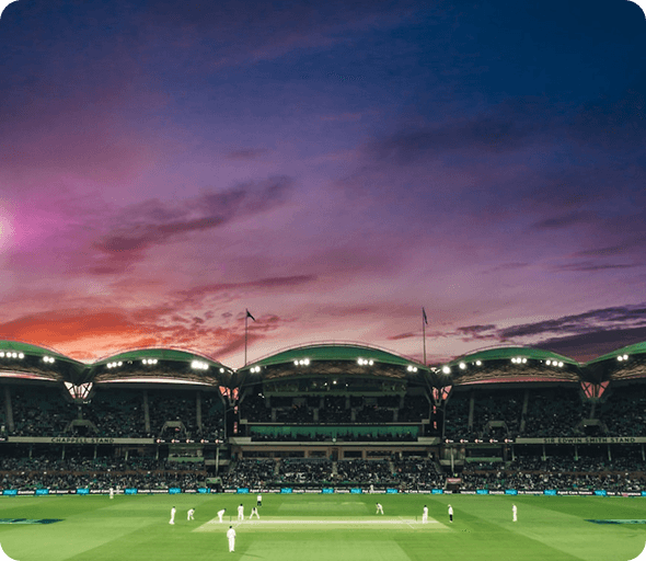 Cricket stadium filled with spectators at sunset