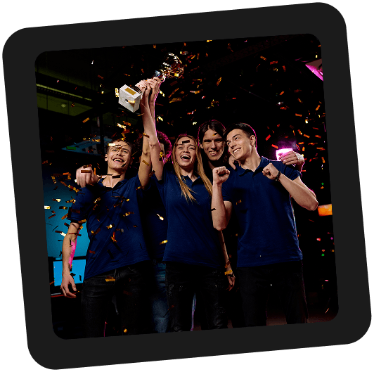 Team celebrating a fantasy sports win with a trophy and confetti