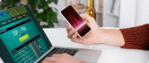 Laptop and smartphone displaying sports analytics dashboards