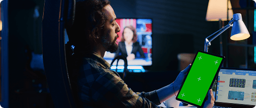 Developer reviewing interfaces across multiple monitors and a tablet