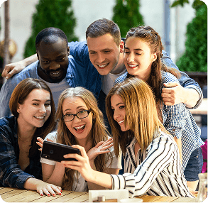 Group of friends smiling together while taking a selfie