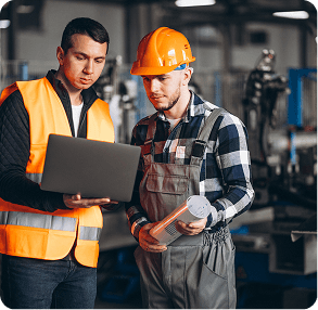 Engineers reviewing a laptop inside an industrial plant