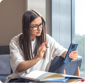 Student studying with notebooks and a smartphone