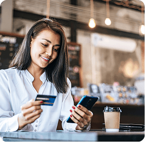 Professional using a smartphone in a modern banking lobby