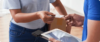 Customer completing a card payment during a package delivery