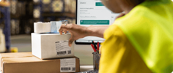 Warehouse worker packing ecommerce orders for shipment