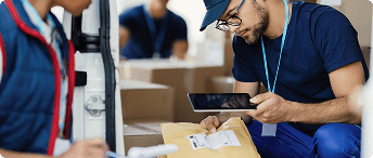 Warehouse team reviewing shipping operations on a tablet