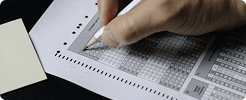 Student completing an assessment on a standardized answer sheet