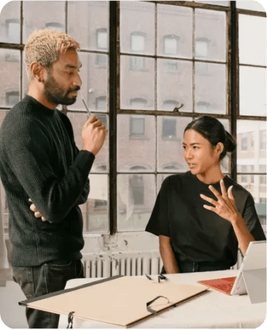 Two colleagues discussing financial product ideas