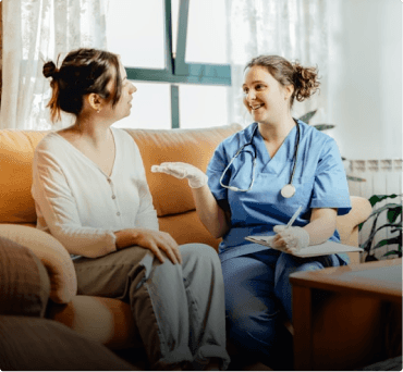 Healthcare professional speaking with a patient at home