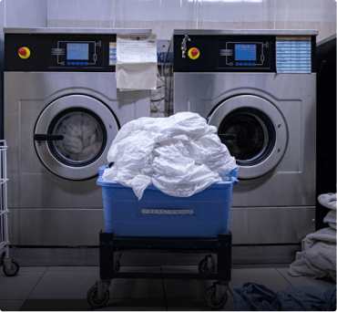 Industrial washing machines with a laundry cart