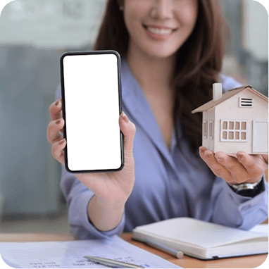 Real estate agent holding a smartphone and a model house