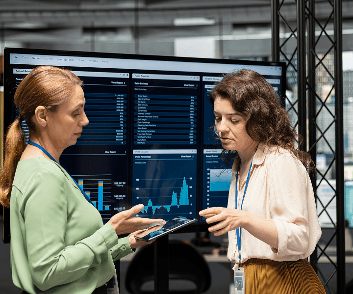 Professionals reviewing property valuation analytics on a large display