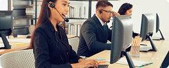 Customer support team wearing headsets in a modern office