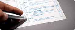 Hand marking a selection on a review checklist form