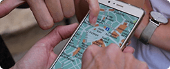 Two people exploring a map application on a smartphone