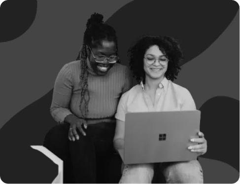 Two professionals collaborating over a laptop