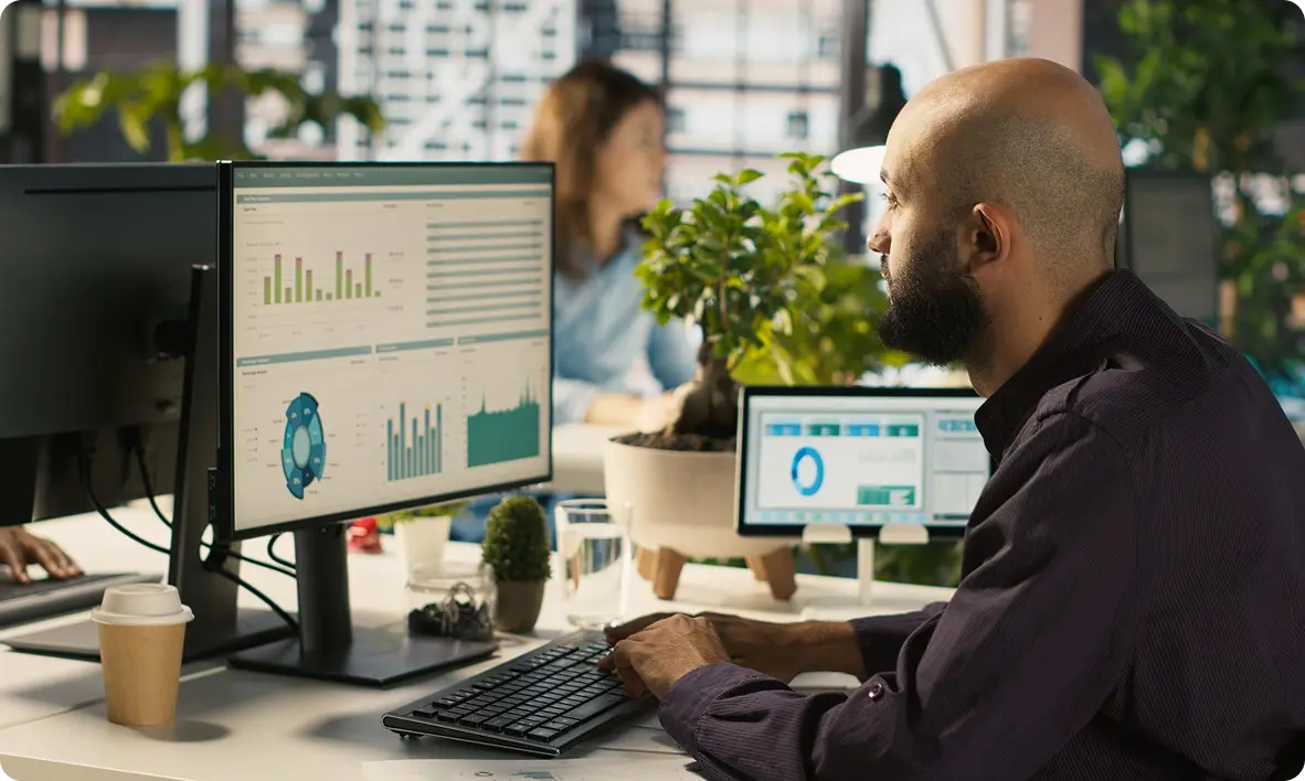 Data analyst reviewing charts and dashboards in a bright office