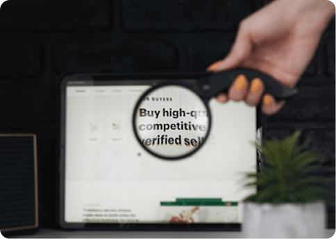 Magnifying glass held over a tablet screen