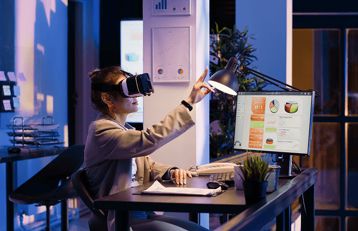 Professional using a VR headset at a desk with analytics displays