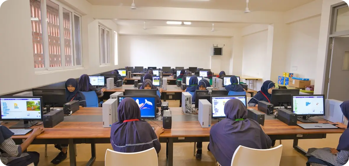 Students in a computer lab using training software at desktop workstations